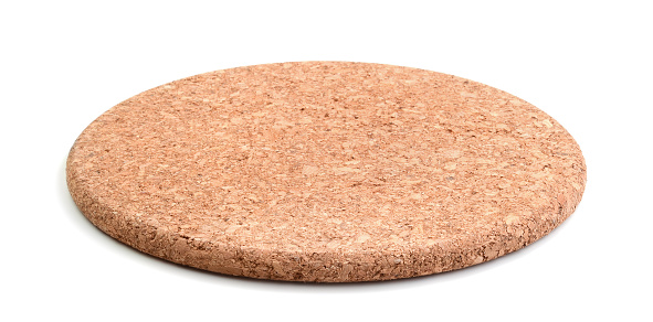 Round cork stand under the hot isolated on a white background