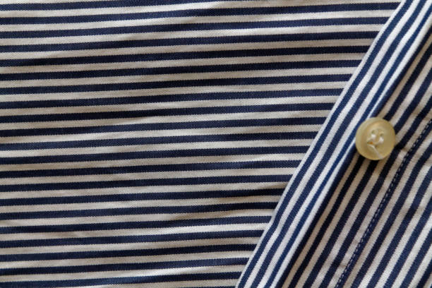 istock Closeup of blue and white stripped fabric texture with button 895692026