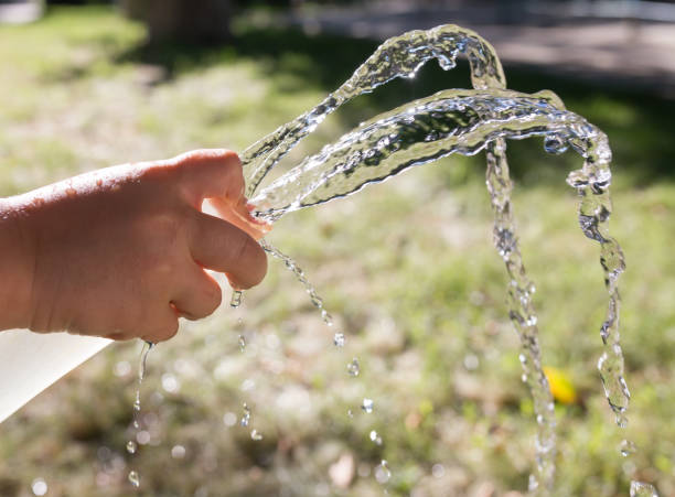 istock water from the hose outdoors 895696772