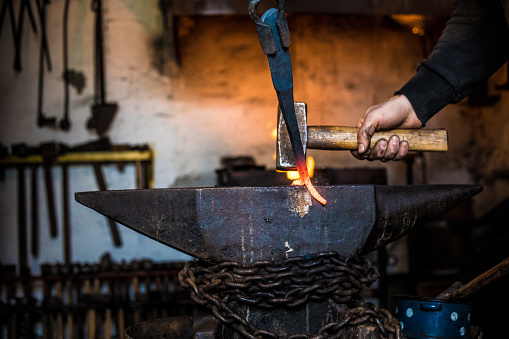 Blacksmith Designing Knife Handle on Anvil.