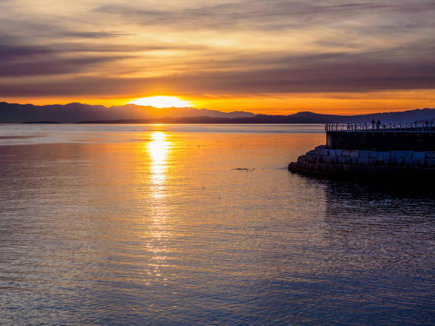 istock Sunset at the breakwater in Victoria BC, Canada 895699346