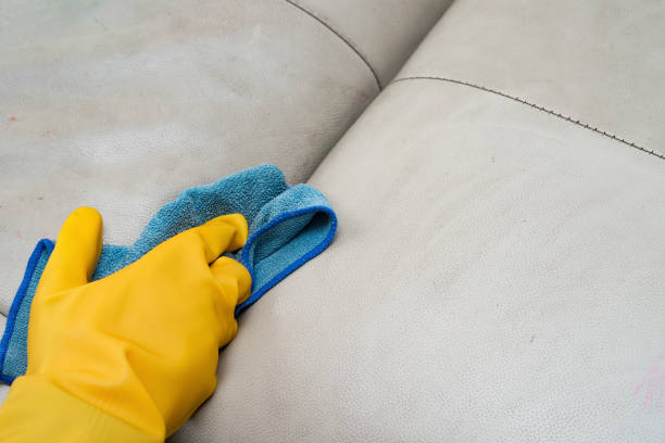 istock cleaning leather sofa at home with wet towel 895699528