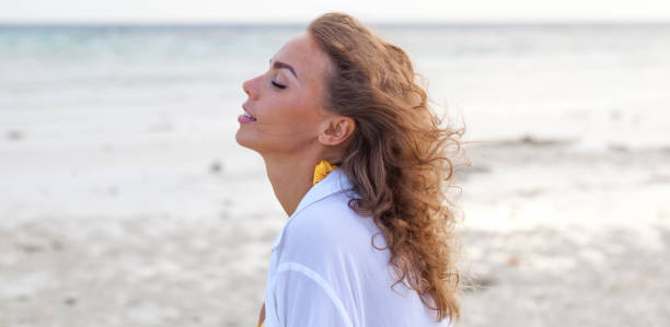 istock Woman enjoy sea scent smelling wind 895705678