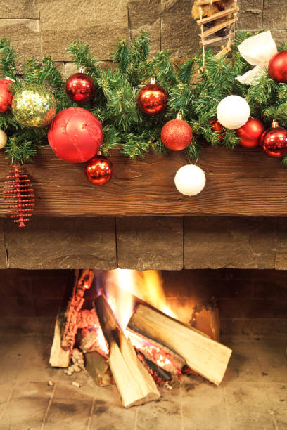 istock New Year / Christmas tree with colorful festive decorations on the fireplace 895706162