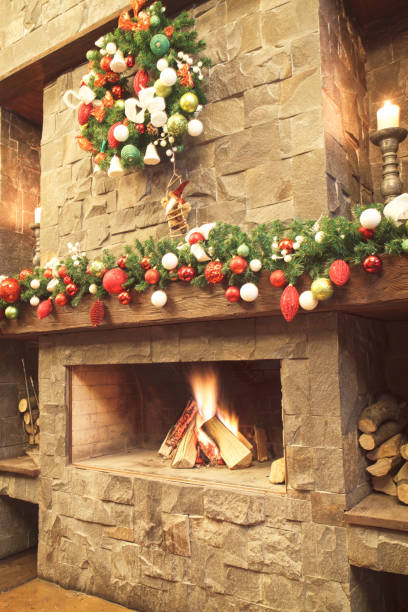 istock New Year / Christmas tree with colorful festive decorations on the fireplace 895706214