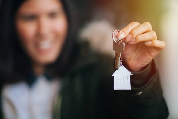 istock Female hand holding house key 895713516
