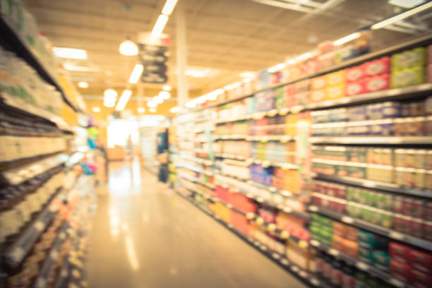 istock Blurred soda, bottled tea, juices in retail store 895715932
