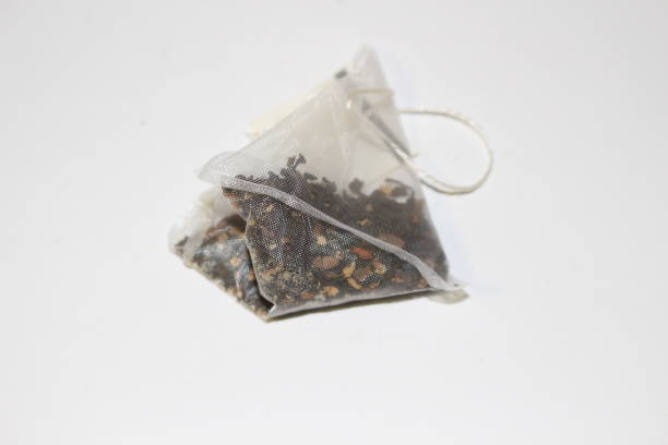 istock Green tea bag isolated on white background 895716226