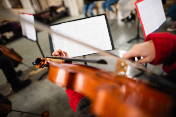 istock Playing violin in a youth orchestra 895719782