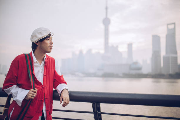 istock Man with guitar outdoors 895728418