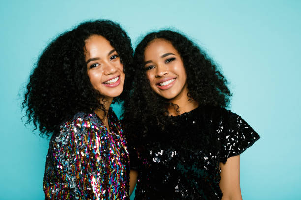 istock Smiling friends standing at blue background in studio 895728896