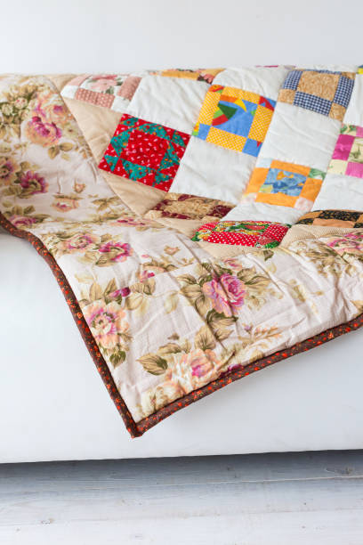 istock patchwork, ornament, home concept. neat loud-coloured covering with pattern from abstract images and outstanding prints of red roses and white chamomile 895728930