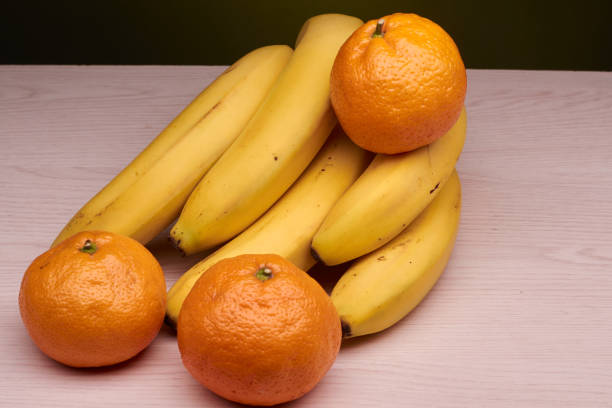 istock bananas and tangerines on the table 895743610