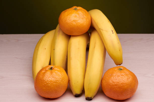 istock bananas and tangerines are located on the table 895743640