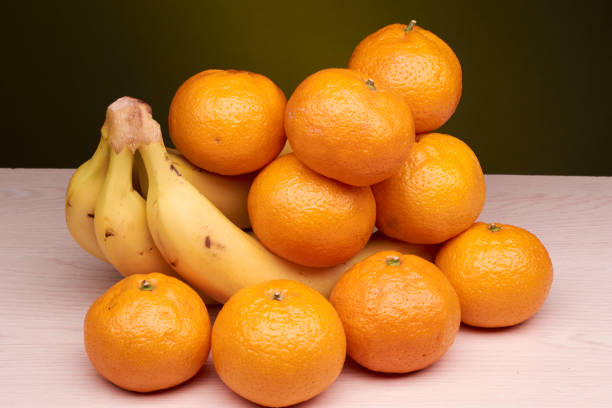 istock appetizing and delicious bananas and tangerines 895743788