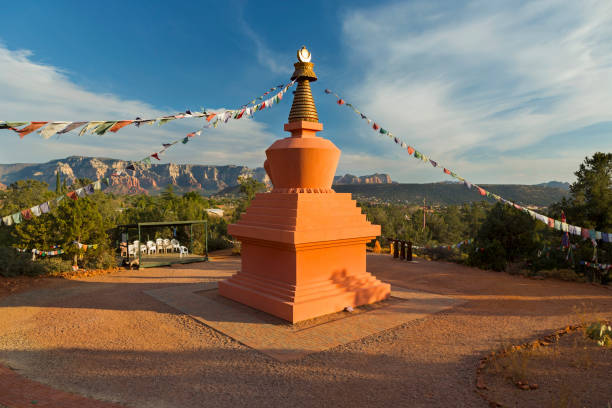 Amitabha Stupa Peace Park Sedona Arizona Amitabha Stupa and Prayer Flags with Distant Red Rock Landscape in Peace Park, Sedona Arizona stupa stock pictures, royalty-free photos & images