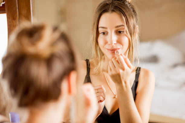 istock Woman applying lipstick 895749754