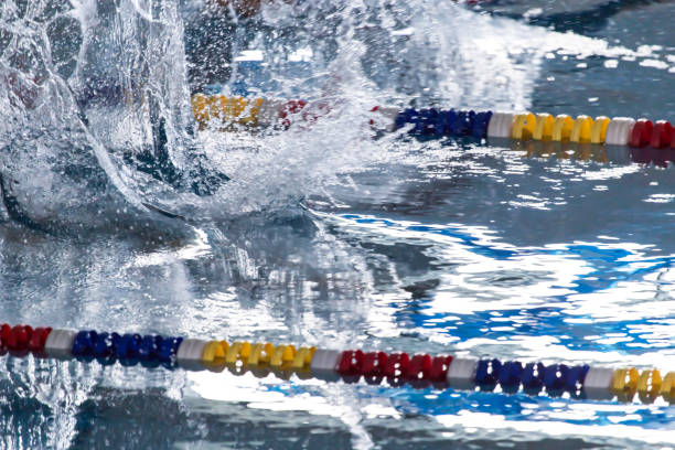 istock People with splashes of dives in the pool 895763356