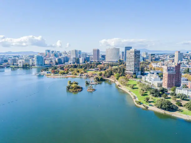 Aerial view above Lake Merritt in Oakland, California. Looking across the lake at downtown Oakland with skyscrapers in the distance.