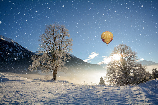 View to a winter landscape with mountain range and hot air balloon, Gasteinertal valley near Bad Gastein, Pongau Alps - Salzburg Austria Europe