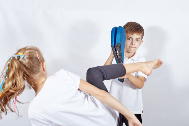 istock Boy holding the simulator girl is hitting a kick 895769404