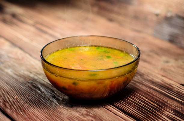 Vegetable soup in glass bowl on wooden table