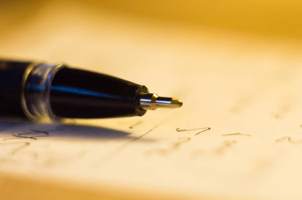 istock ball point pen and a sheet of paper 895781468