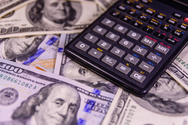 istock Modern calculator on a one hundred dollar bills 895790946