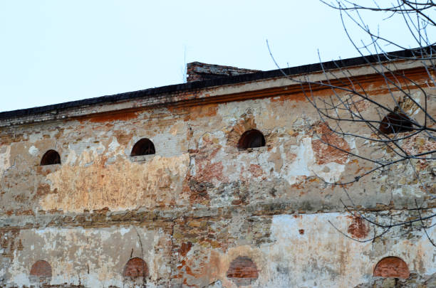 Stone wall of the ancient fort with windows