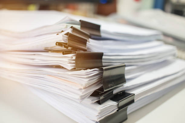 istock Paper stack, Pile of unfinished documents on office desk related to business functions. Stack of business papers for Annual Report files, Document is written,drawn,presented. Business offices concept. 895791274
