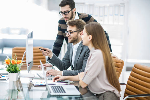 istock professional business team is developing a new project ,sitting behind a Desk in a modern office 895793978
