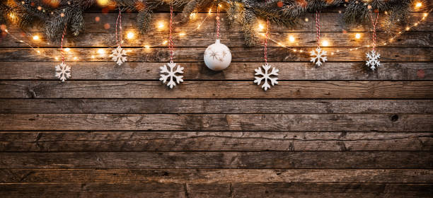 Christmas background with wooden decorations and spot lights.