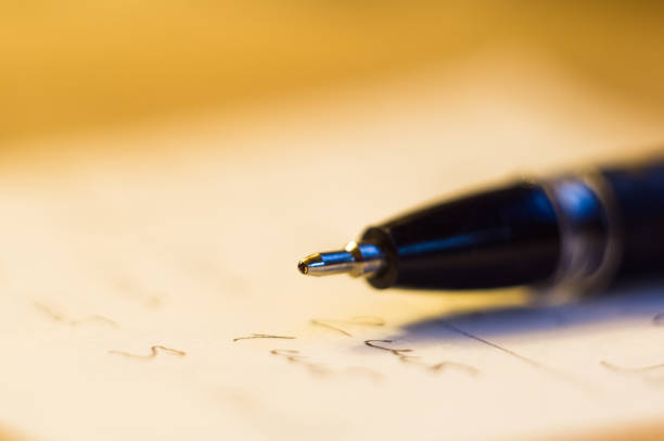istock ball point pen and a sheet of paper 895799700