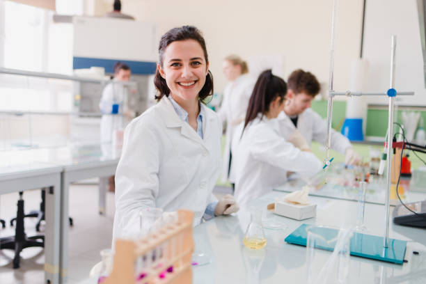 istock Young college engineering student looking at camera in genetics laboratory with a lovely facial expression 895801910