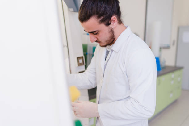 istock Young male engineering student doing an experiment in genetics laboratory by himself in laboratory 895801934