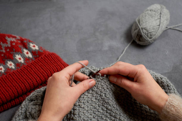 istock Close-up of hands knitting. 895805650