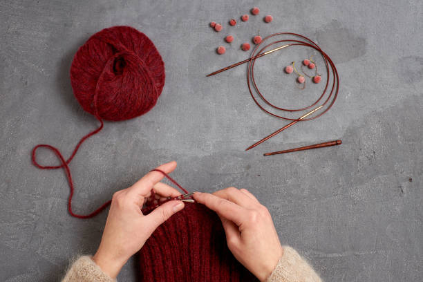 istock Close-up of hands knitting. 895805760