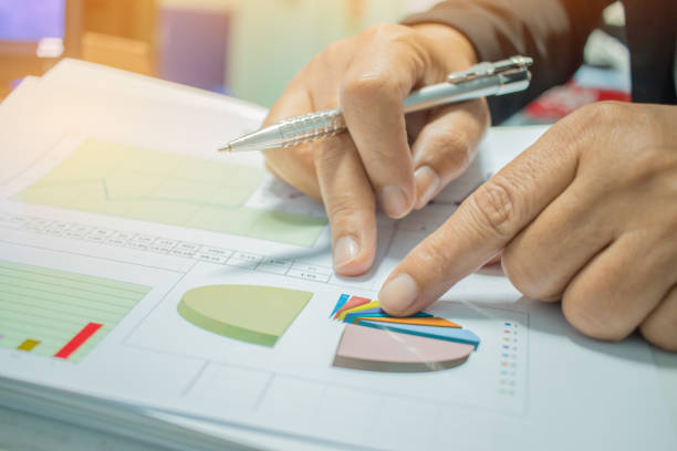 istock Businessman Preparing reports papers with graphs, charts on Stacks of documents files for finance in office. Piles of unfinished document achieves with paper clip. Concept of Business Annual Report. 895808056