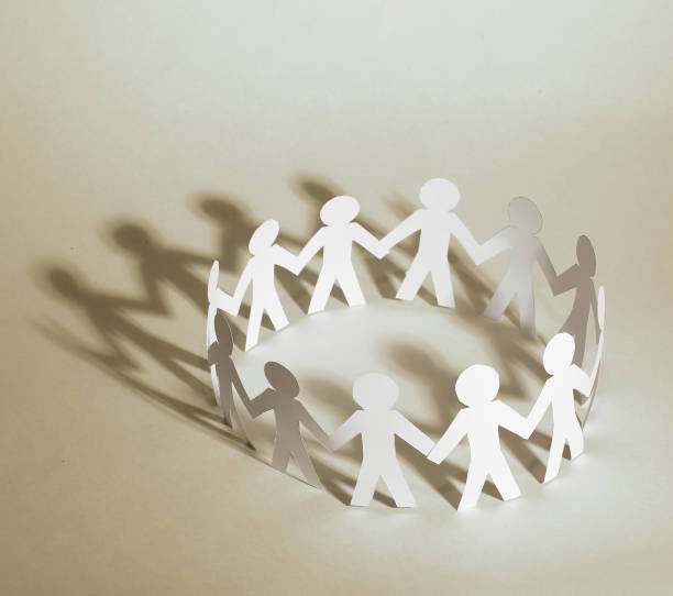 istock business background.team paper men standing holding hands 895813684