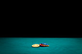 istock Poker chips on green felt casino table 895813942