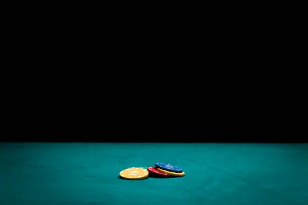 Photo of Poker chips on green felt casino table