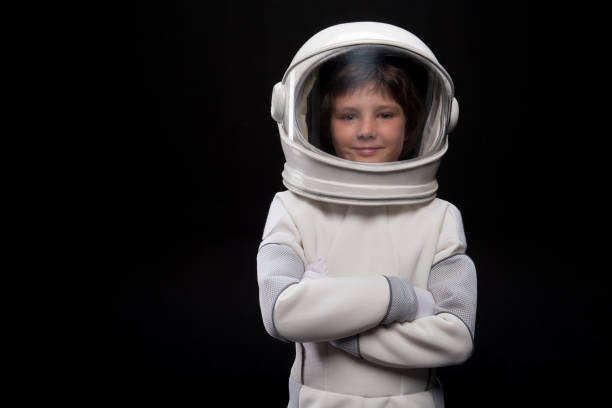 istock Cute child astronaut is posing confidently 895816180
