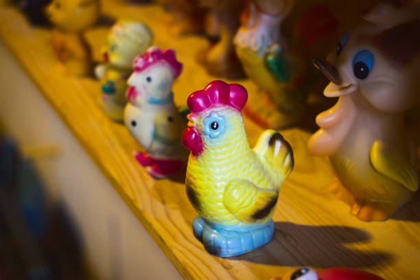 istock Beautiful bright plastic toy rooster on wooden 895826638