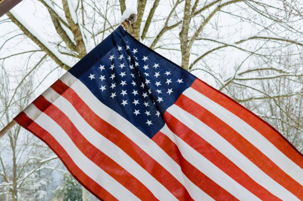 istock American Flag with snow background 895826858