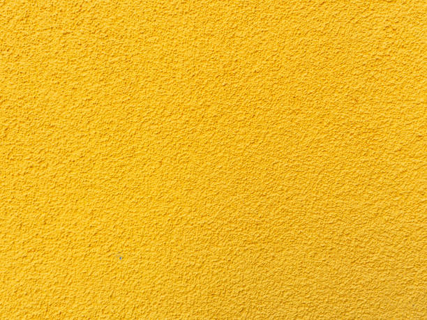 istock Yellow wall texture background. Textured concrete plaster with spraying in the form of drops 895829454