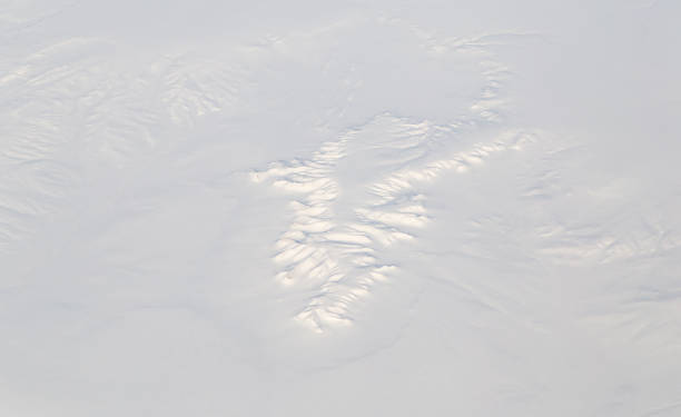 istock snowy land. view from the airplane 895848238
