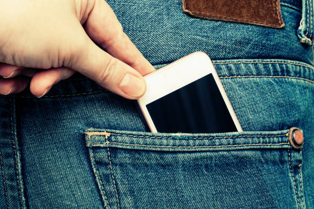 istock The hand pulls the phone out of the jeans pocket. 895848284