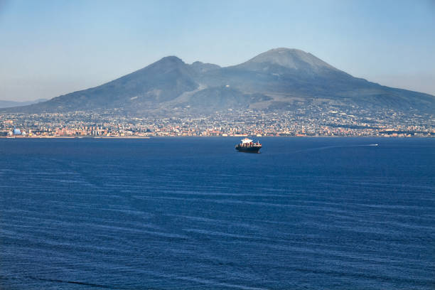The view on the great Mount Vesuvius, the stratovolcano in the Gulf of Naples with one cargo ship , Italy