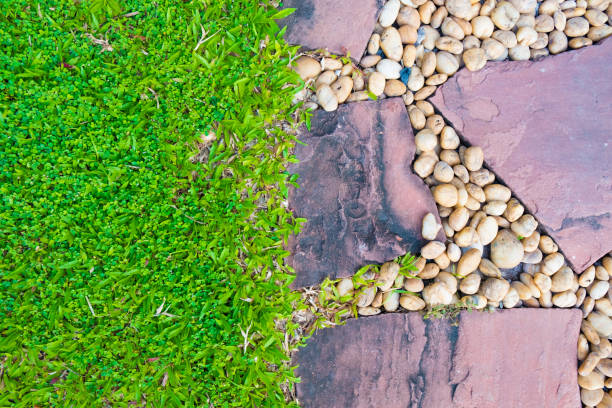 istock Green grass field with stone pathway and small rock decoration. 895853886