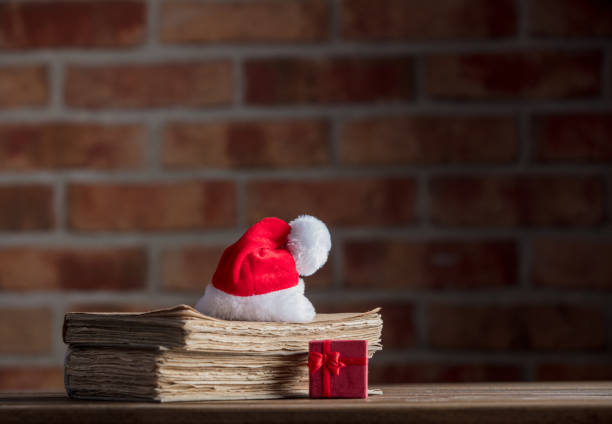 istock Christmas hat and old books 895856334